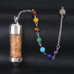 Crystal pendulum with chakra beads,  silver metal,  and orange crystals.