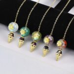 Gold-chained pendulums with colorful, star-embellished beads.
