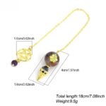 Gold-chained pendulum with gemstone sphere and star design.