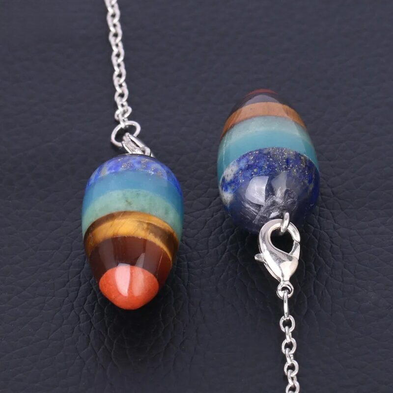 Multi-stone pendulum necklace with different colored stones and metal chain.