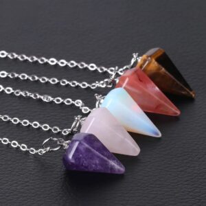 Colorful gemstone pendulums, amethyst, rose quartz, tiger's eye, and opal, on silver chains.