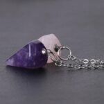 Two amethyst and rose quartz pendulum necklaces.