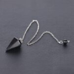 Black gemstone pendulum on silver chain.