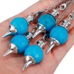 Four teal-blue gemstone pendulums with silver metal points.