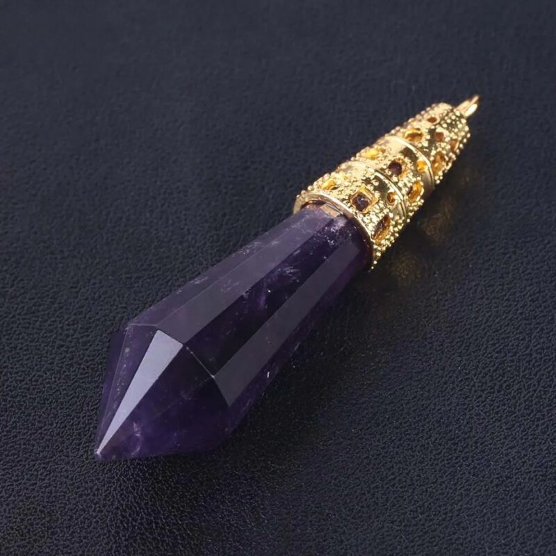 Amethyst point pendant with gold filigree setting.