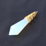 Light-blue opal teardrop pendant with gold filigree details.