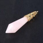Pink quartz crystal pendant with gold filigree.