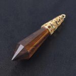 Tiger eye crystal pendant with gold accents.