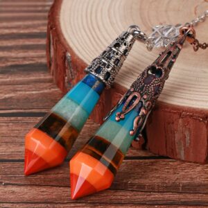 Multicolored layered crystal pendulum,  decorative metal accents.