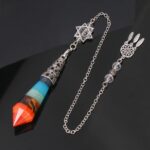 Multi-colored gemstone pendulum with metal chain and charm.