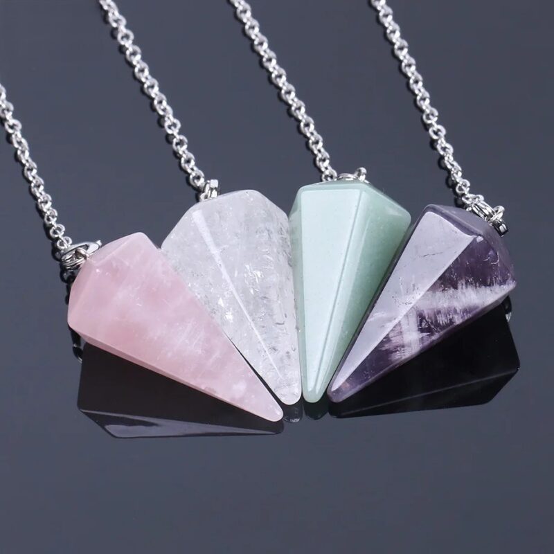 Four crystal pendulums, rose quartz, clear quartz, green aventurine, and amethyst,  on chains.