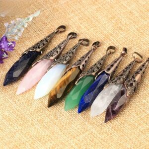 Colorful gemstone pendants, various types of crystals,  in metal settings.