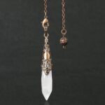 Crystal pendulum with copper-toned metal accents.