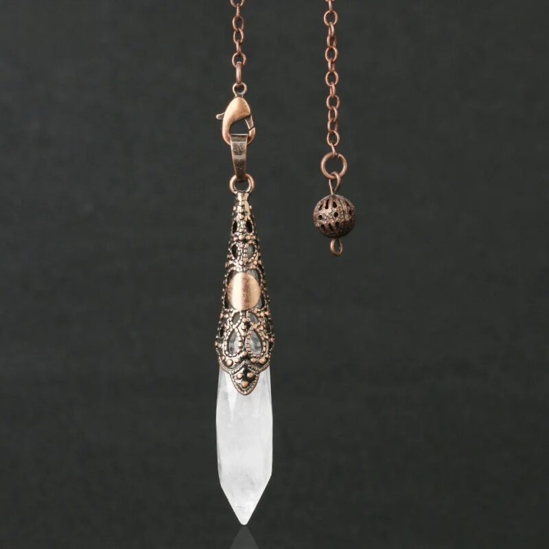 Crystal pendulum with copper-toned metal accents.