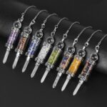 Crystal pendulums, various colors, small stones inside, clear glass tubes, silver metal accents.
