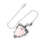 Pink quartz pendulum with silver chain and ornate details.