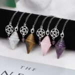 Crystal pendulums with different stones, amethyst, rose quartz, tiger's eye, and lapis lazuli.  Silver chain.