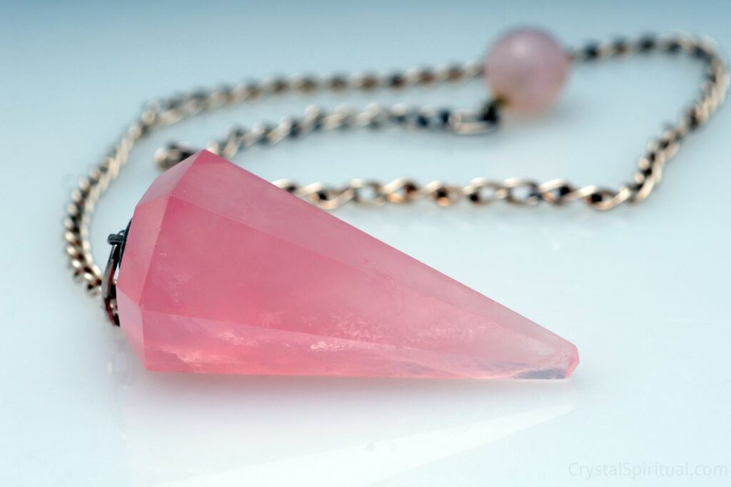 Pink rose quartz pendulum with silver chain.