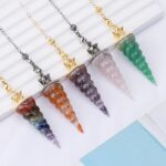 Colorful crystal pendulum pendants, various colors, on chains.