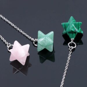 Two gemstone star pendulums, one rose quartz and one green aventurine, on silver chains.