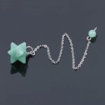 Green crystal star pendulum with silver chain.
