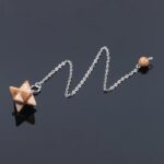 Brown star-shaped pendulum with silver chain.
