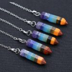 Seven chakra pendants,  multi-colored stones,  silver chain.