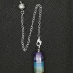 Seven chakra pendulum, metal chain, stone layers.