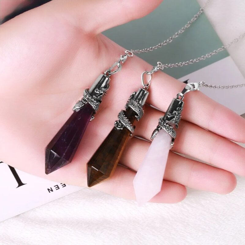 Three gemstone pendants with dragon design, amethyst, tiger's eye, and rose quartz.
