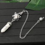 White onyx pendulum with star-shaped metal cage, chain, and metal ball.