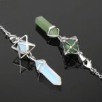 Crystal pendants,  opal and green,  in silver settings.