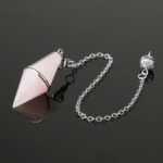 Pink rose quartz pendulum with silver chain.