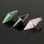 Three gemstone pendulums: green aventurine, amethyst, and rose quartz.
