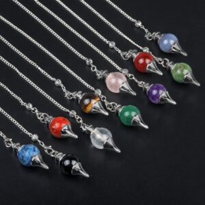 Assorted gemstone pendulums with metal chains.