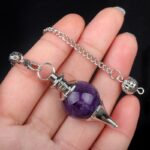 Amethyst pendulum with silver chain and metal accents.