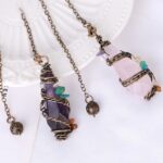 Three gemstone pendulums, amethyst, rose quartz, wired with small stones.