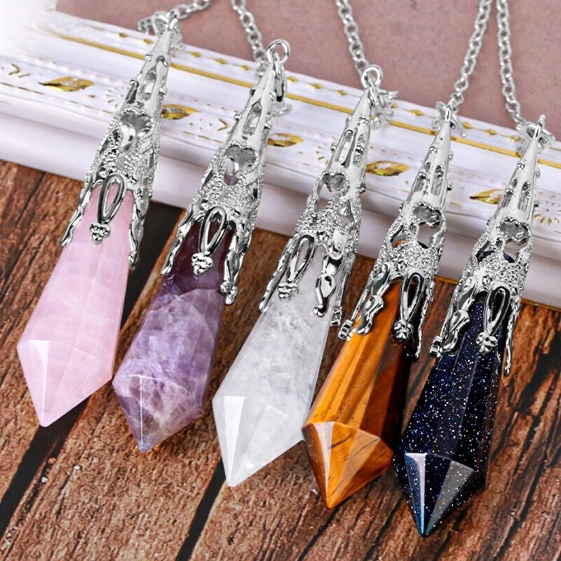Vintage-Filigree-Metal-Crown-Pendulum-CS006-1 Set of gemstone pendulums, various colors including rose quartz, amethyst, white quartz, tiger's eye, and blue spinel, each with a decorative silver-toned metal top.