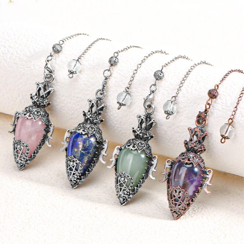Three gemstone pendulums,  rose quartz, lapis lazuli, and amethyst, with ornate silver/bronze settings and chains.  Jewelry.