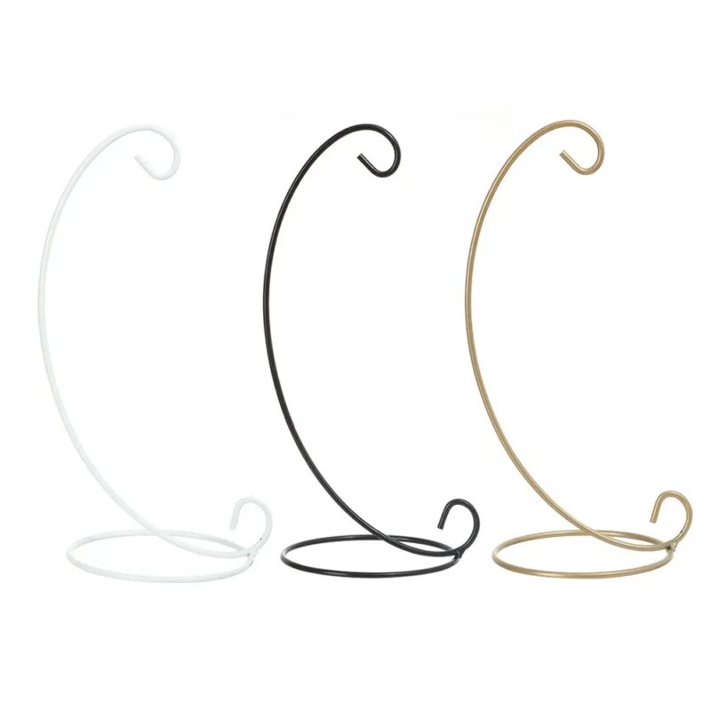 Three metal plant hangers, white, black, and gold.
