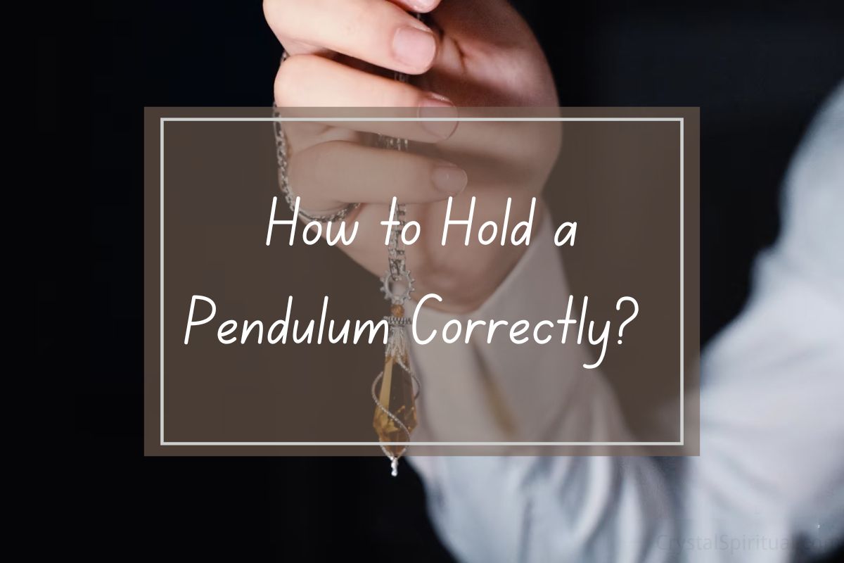 Hands holding a pendulum,  how to hold a pendulum correctly.