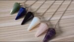 Colorful crystal pendulums, various gemstones.