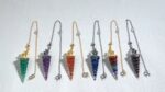 Colorful gemstone pendulums on chains.