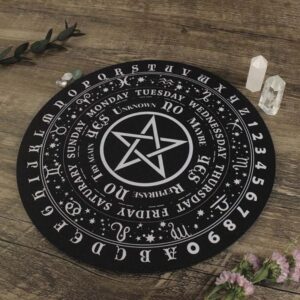 Black Ouija board with white symbols,  star,  days of the week, numbers, and letters.  Wooden table.