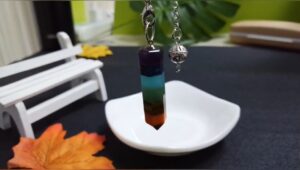 Multicolored chakra pendulum, layered crystals, silver chain.
