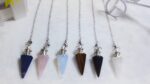 Crystal pendulums, various colors, on chains.