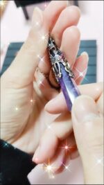 Purple amethyst crystal pendant, ornate silver setting.