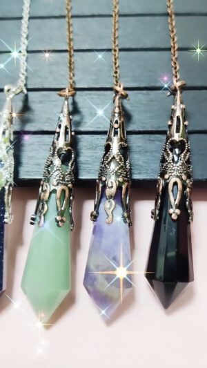 Four gemstone pendulums, various colors (green, purple, amethyst, black) with ornate metal accents.