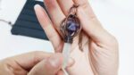 Amethyst crystal pendulum necklace, clear quartz point, copper accents.