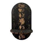 Black wooden wall shelf with moon phases and floral designs.