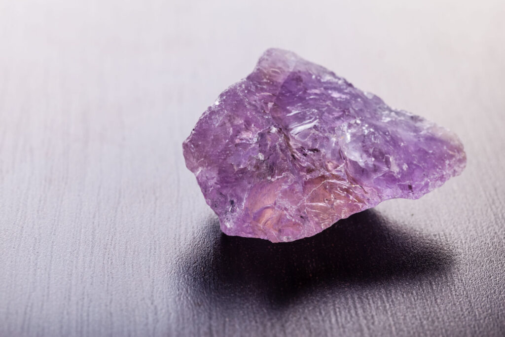 Raw amethyst crystal, purple rough stone.